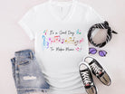 It's a graphic tee from Anchored Grace Boutique with a "It's a Good Day to Make Music" design in vibrant colors.