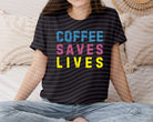 Coffee Saves Lives graphic tee by Anchored Grace Boutique, featuring a stylish design on a casual t-shirt.
