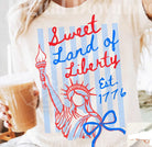 Black Sweet Land of Liberty graphic tee by Anchored Grace Boutique featuring patriotic design and bold lettering.