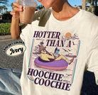 Black graphic tee from Anchored Grace Boutique featuring bold "Hotter Than a Hoochie Coochie" text in vibrant colors.