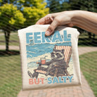 Feral But Salty graphic tee by Anchored Grace Boutique featuring bold lettering and casual fit on soft fabric.