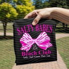 Salty Babes Beach Club graphic tee by Anchored Grace Boutique, featuring a colorful beach scene on a casual cotton t-shirt.