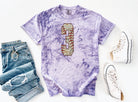 Camo baseball graphic tee with bold numbers, featuring a casual style from Anchored Grace Boutique.