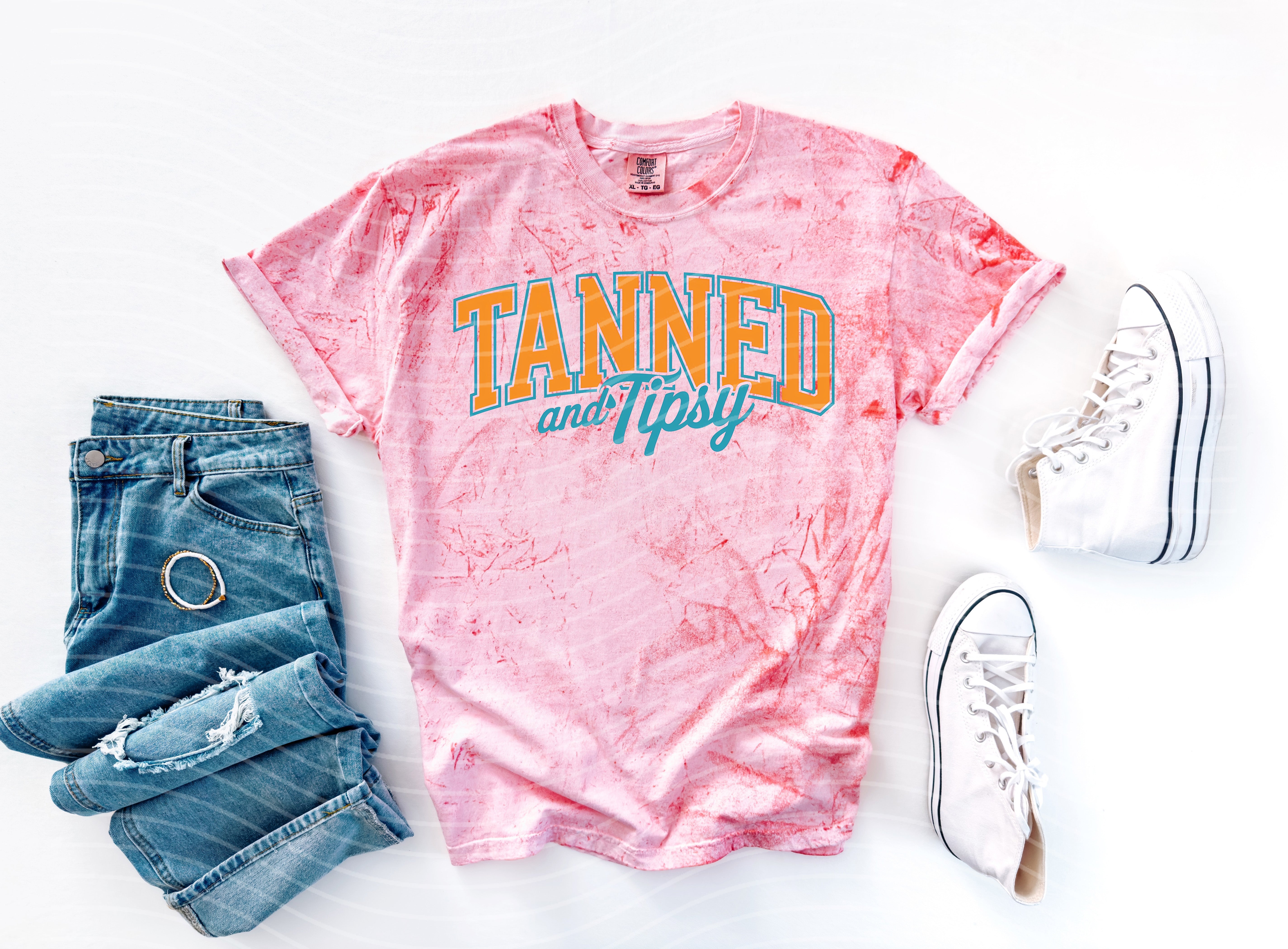 Tanned and Tipsy graphic tee by Anchored Grace Boutique featuring a casual, stylish design on a comfortable cotton shirt.