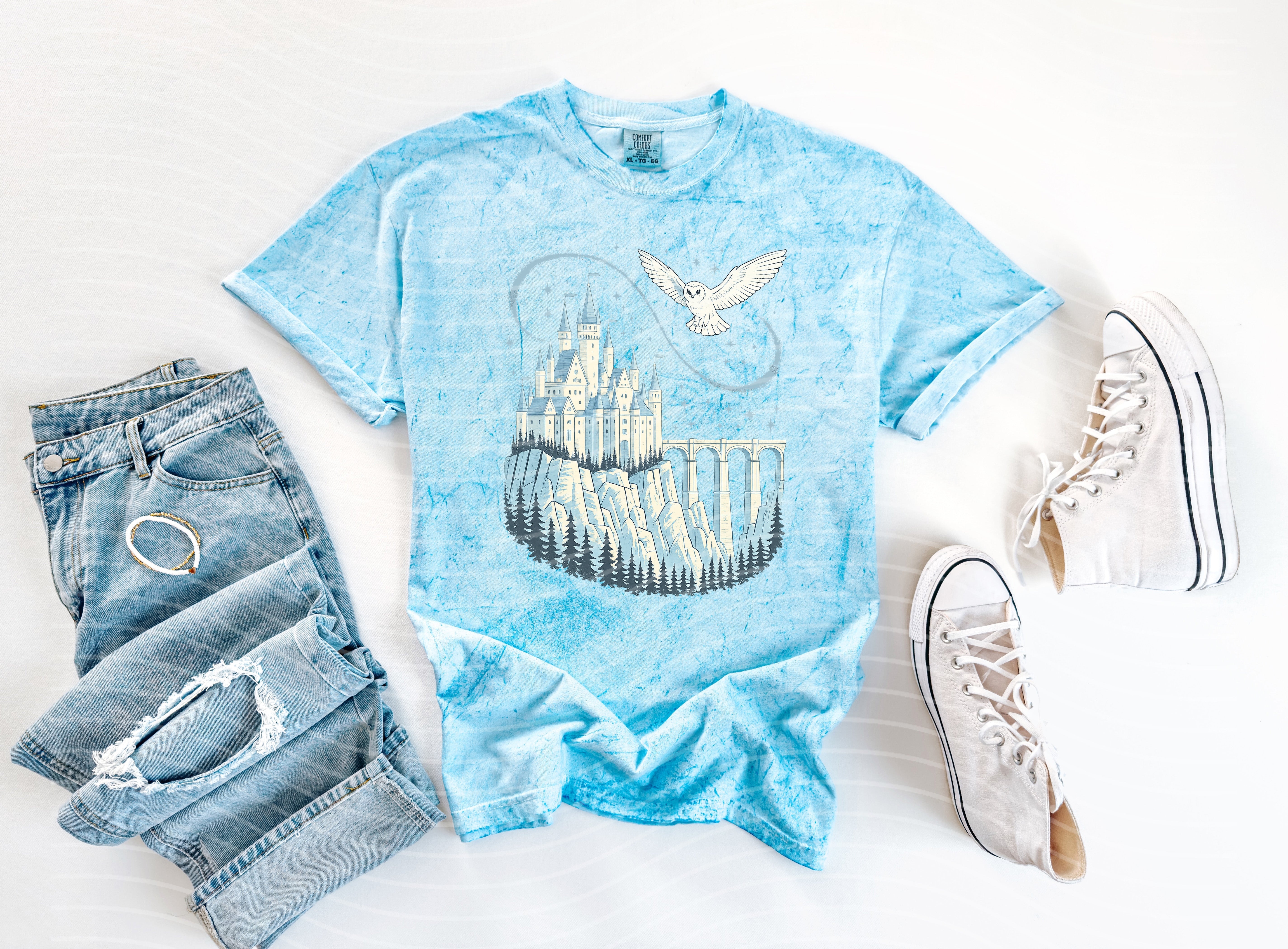 Anchored Grace Boutique Hedwig & Castle graphic tee featuring a colorful Harry Potter-inspired design on a casual cotton shirt.
