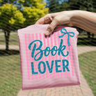 White graphic tee with book lover design from Anchored Grace Boutique, featuring a literary-themed illustration on the front.