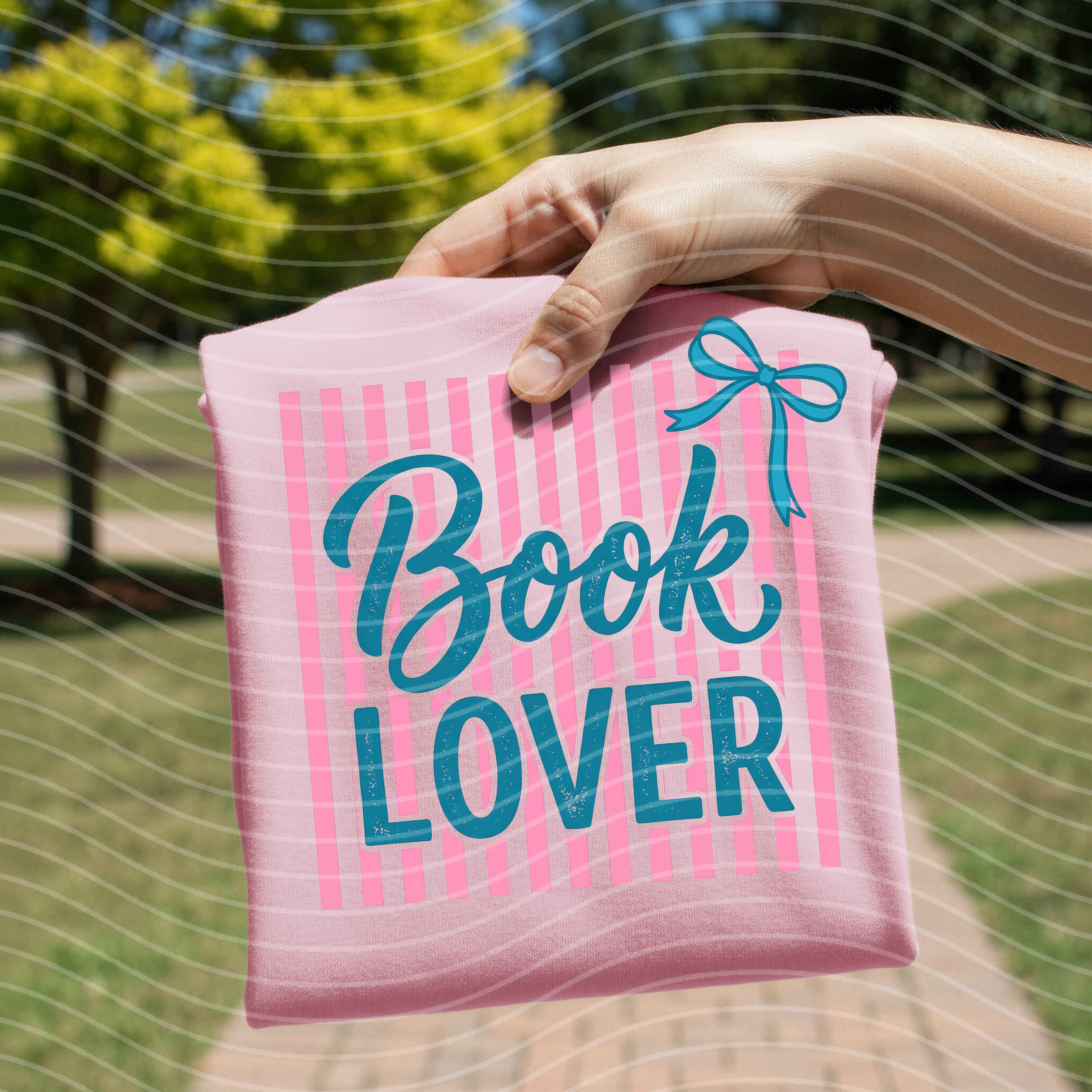 White graphic tee with book lover design from Anchored Grace Boutique, featuring a literary-themed illustration on the front.