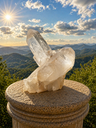 Clear quartz point cluster from Practical Magic Store, featuring multiple transparent crystal points with natural facets and a rough base.