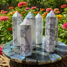 Aura Howlite towers from 1 Practical Magic Store featuring smooth white stone with an iridescent aura finish.