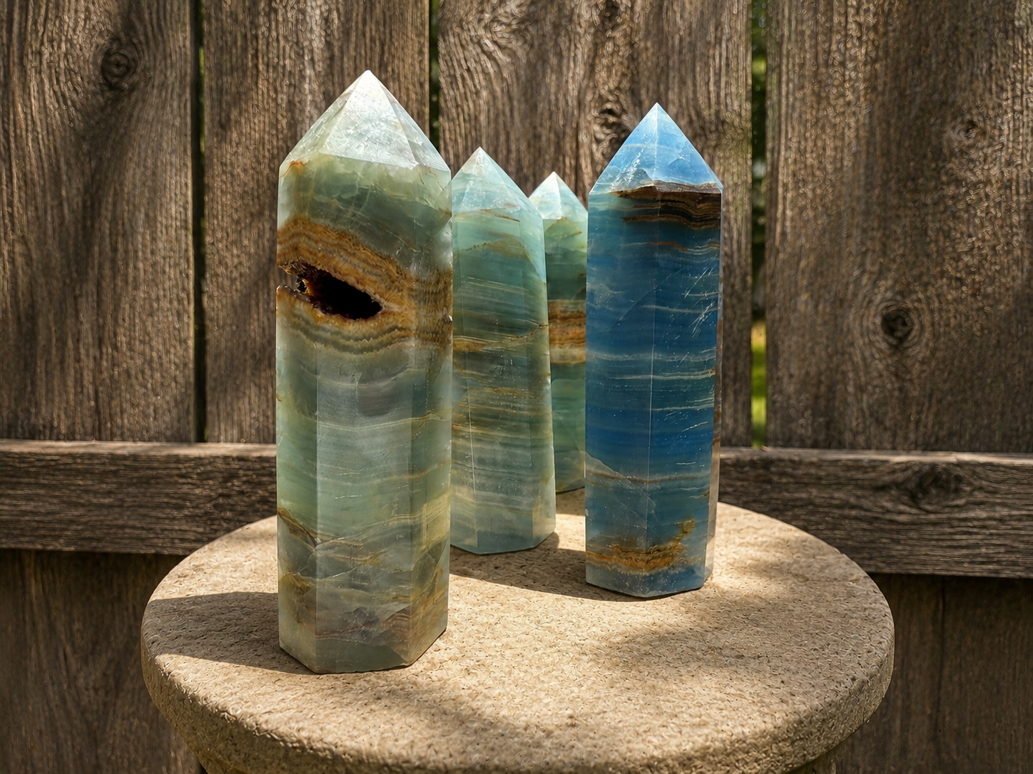 Blue Lemurian Aquatine Onyx tower crystal with deep blue and black tones, polished and standing upright for display or healing purposes.