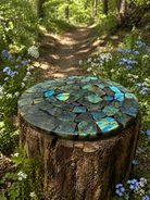 Labradorite gemstone plate with iridescent blue and green flashes, showcasing polished, natural stone with unique patterning.