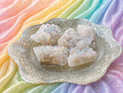 Angel Aura Quartz clusters with iridescent, shimmering crystal formations showcasing vibrant colors and a luminous glow.