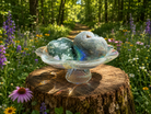 Natural moss agate heart gemstone from 1 Practical Magic Store showcasing green and brown mineral patterns in a polished form.