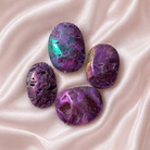 Pink aura druzy sphalerite palmstone from Practical Magic Store, polished pink gemstone with shimmering aura finish, handheld healing stone.