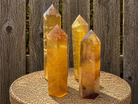 Yellow fluorite tower sculpture from natural stone, showcasing vibrant yellow hues and polished, geometric shape.