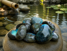 Small labradorite heart pendant from 1 Practical Magic Store, showing iridescent blue and green flashes in polished stone.