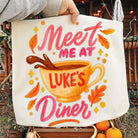 Gray graphic tee from Anchored Grace Boutique featuring "Meet Me at Luke's Diner" text and vintage-inspired design.