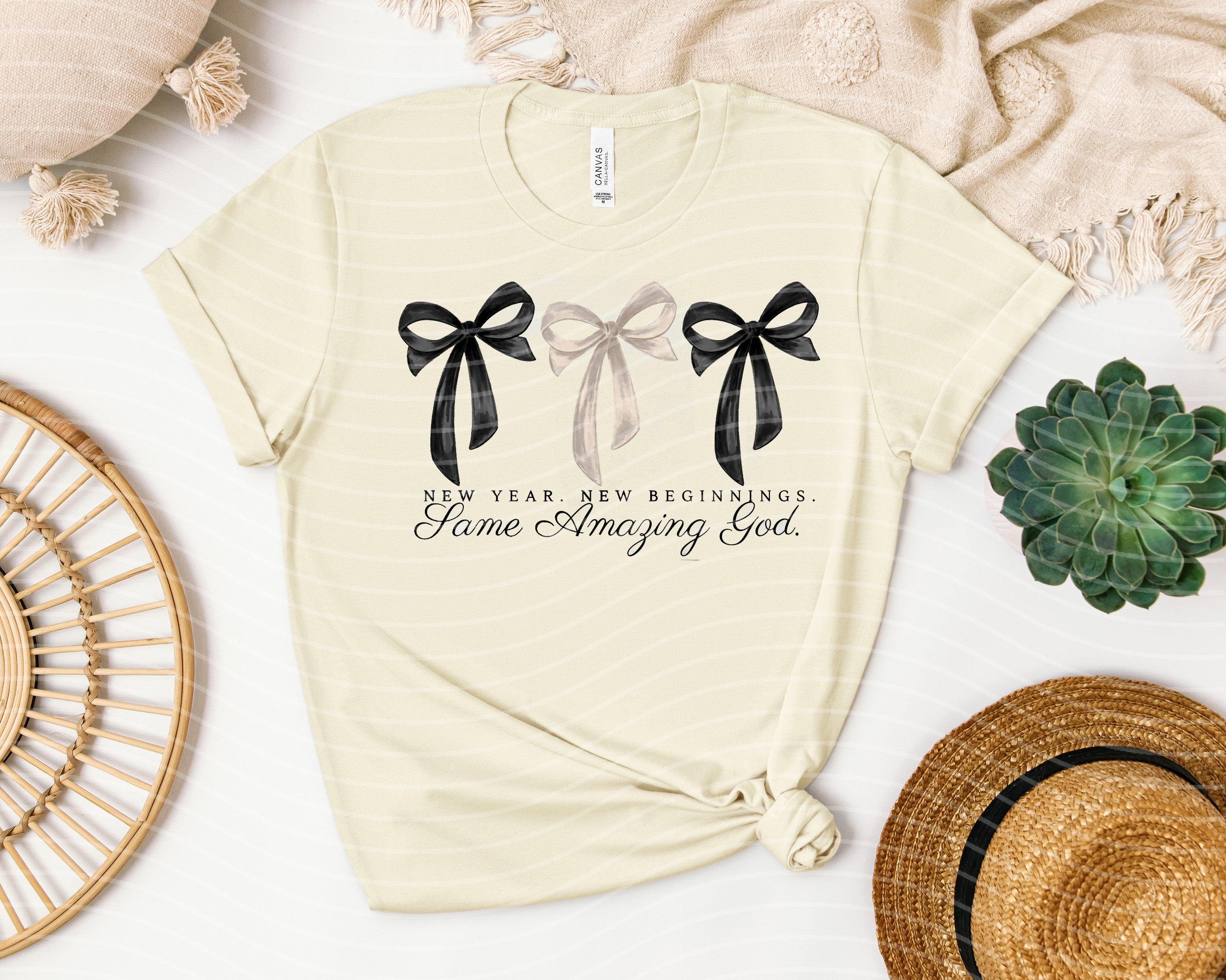 Black graphic tee featuring inspirational "New Year New Beginnings" message with a cross and floral design by Anchored Grace Boutique.