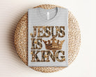 Jesus is King graphic tee by Anchored Grace Boutique featuring a bold religious design on a stylish unisex T-shirt.