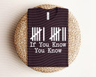 Black graphic tee from Anchored Grace Boutique with "If You Know You Know" design, casual style, and comfortable fit.