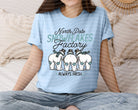 North Pole Snowflakes Factory graphic tee by Anchored Grace Boutique, featuring festive snowflake design on a casual t-shirt.