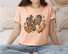 Black monochromatic hearts graphic tee from Anchored Grace Boutique featuring a stylish heart print on soft cotton fabric.