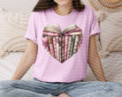 Heart graphic tee in white featuring a book design, from Anchored Grace Boutique's collection of casual graphic tees.