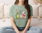 Maybe Perhaps Christmas Means a Little Bit More graphic tee by Anchored Grace Boutique, featuring festive holiday design.