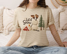 Let It Snow yarn graphic tee by Anchored Grace Boutique, featuring a cozy winter-themed yarn design on a casual graphic tee.