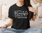 Black graphic tee from Anchored Grace Boutique with "It's a Beautiful Day to Leave Me Alone" slogan and casual fit.