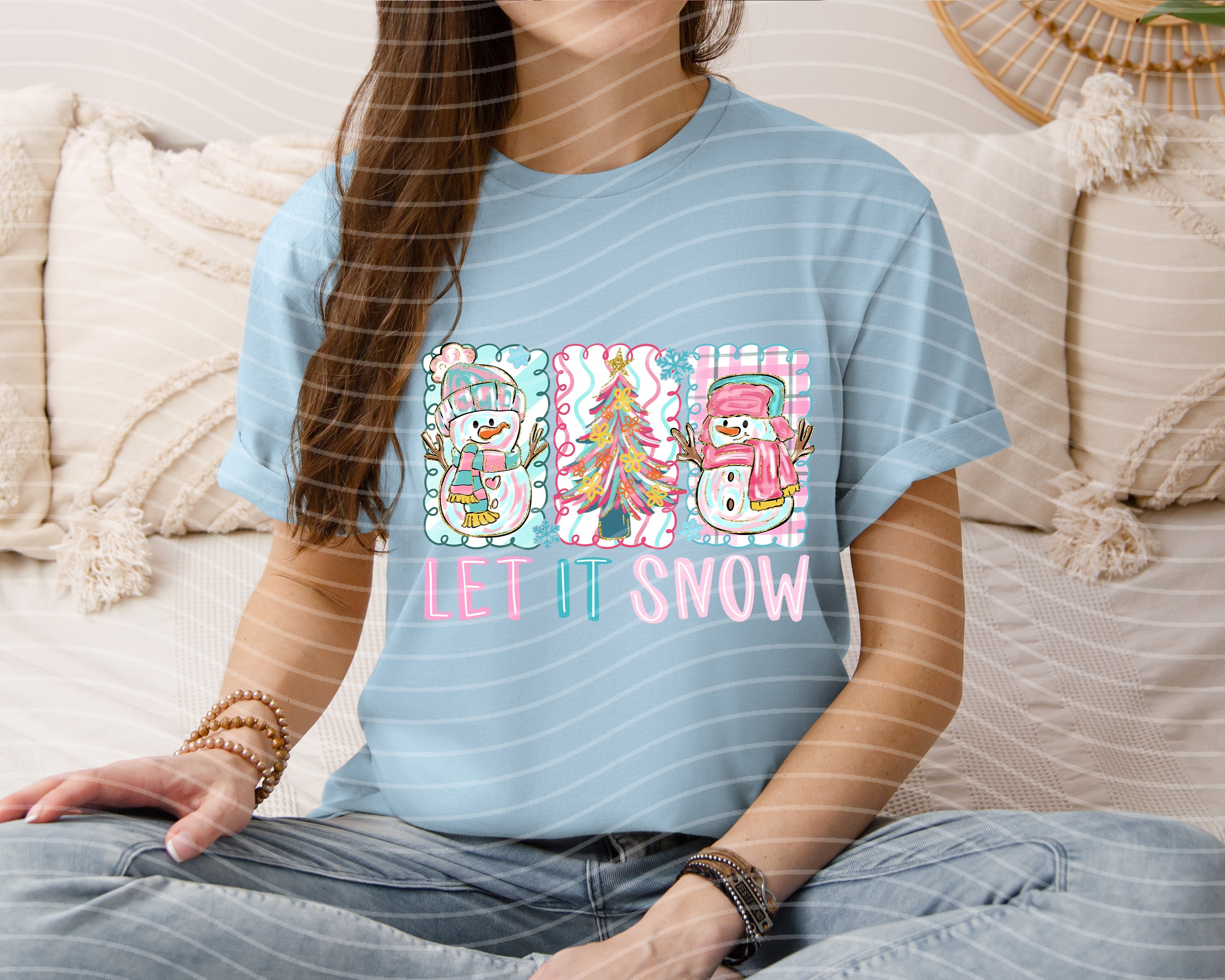 Let It Snow graphic tee by Anchored Grace Boutique featuring a festive winter design on a casual T-shirt.