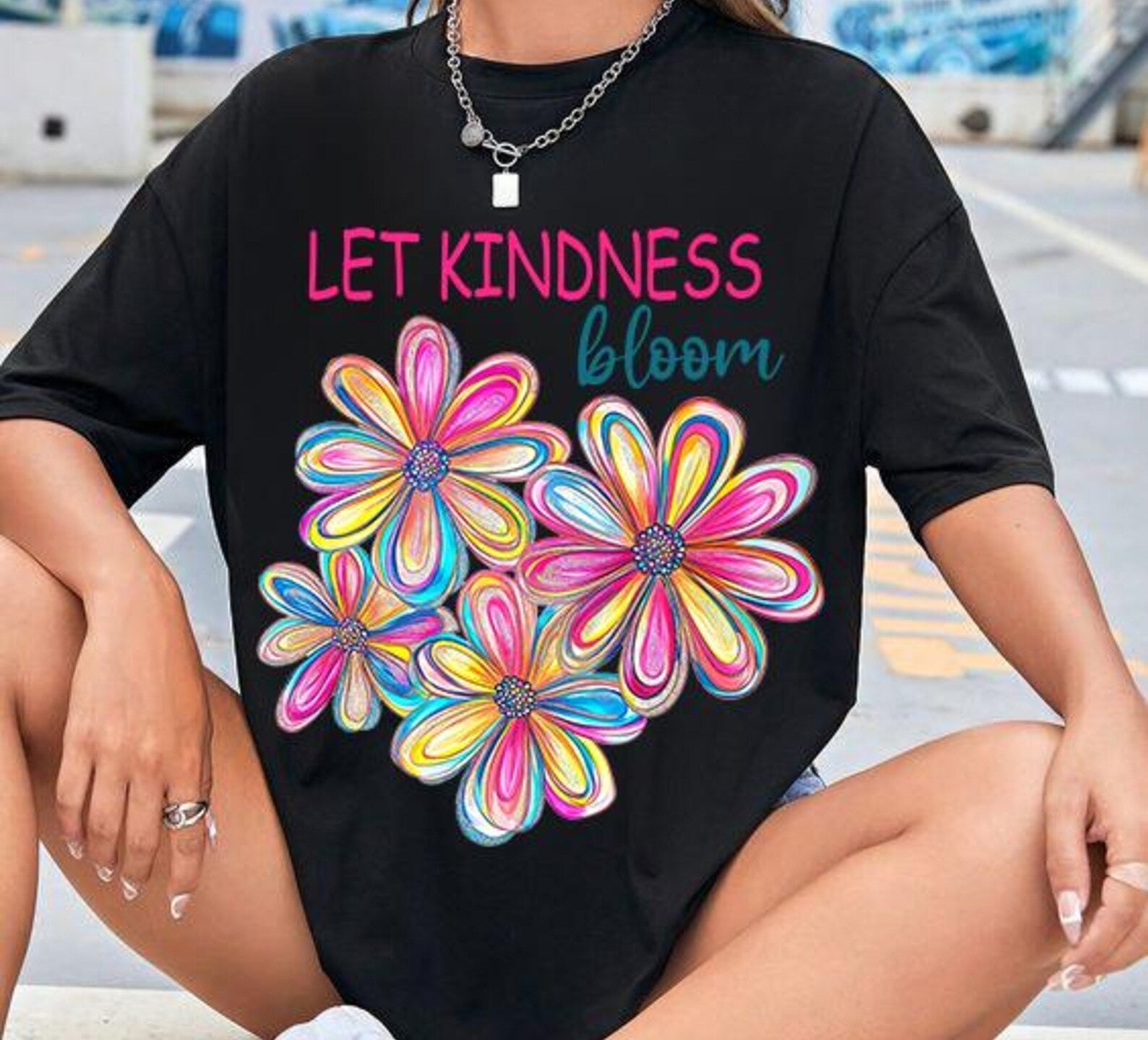 Gray Let Kindness Bloom graphic tee by Anchored Grace Boutique featuring a colorful floral design and uplifting message.