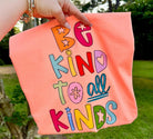 Be Kind to All Kinds graphic tee from Anchored Grace Boutique, featuring colorful text and diverse illustrations on soft fabric.