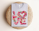 Love Stack Yarn graphic tee by Anchored Grace Boutique, featuring a colorful yarn stack design on a casual cotton t-shirt.