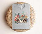 Floral boombox graphic tee from Anchored Grace Boutique featuring vibrant floral and boombox design on a casual t-shirt