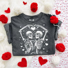 Black and white skellies graphic tee from Anchored Grace Boutique, featuring a stylish skeleton design on a casual t-shirt.