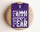 Faith Over Fear graphic tee by Anchored Grace Boutique, featuring bold text design on a casual cotton t-shirt.