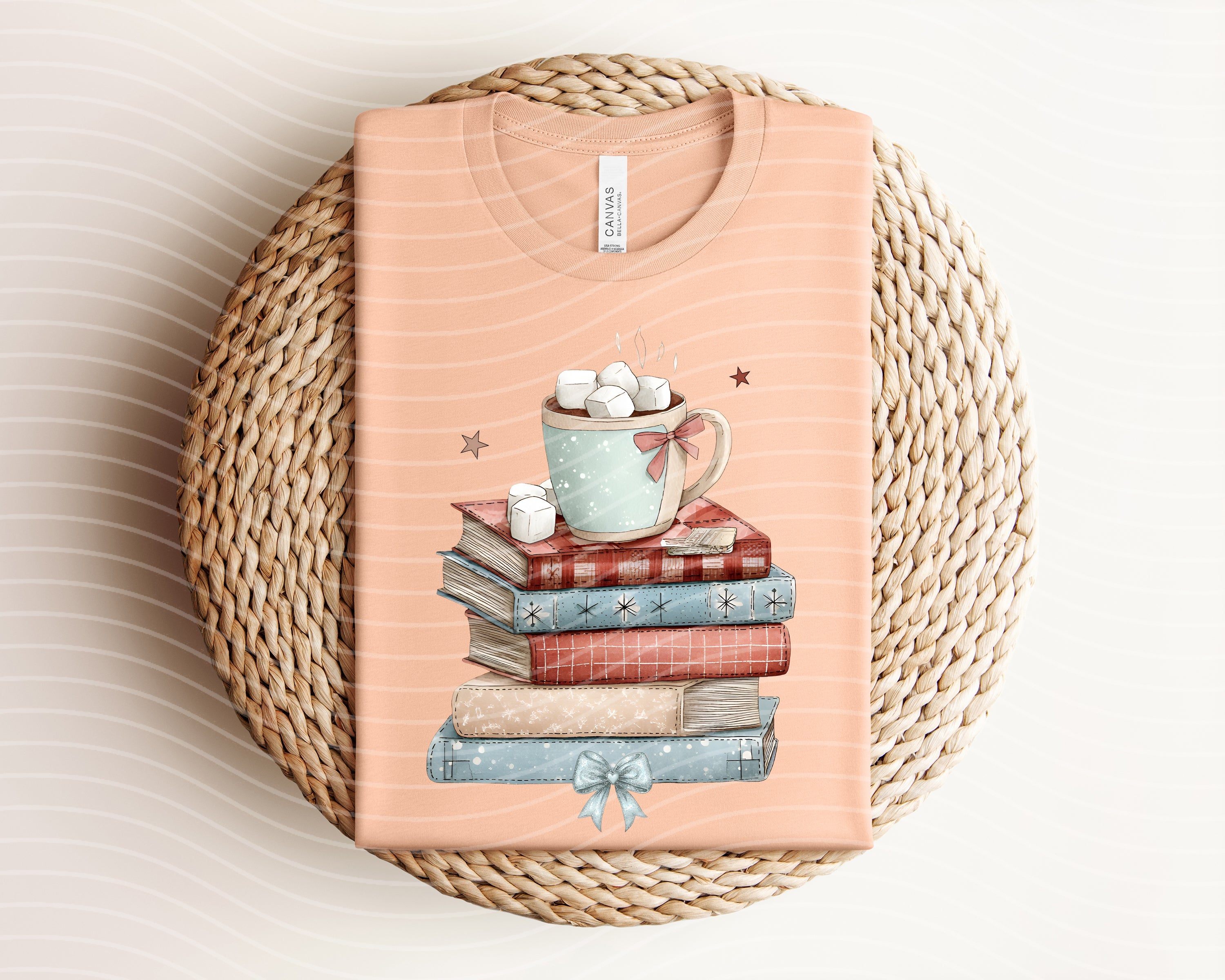 Winter book stack graphic tee by Anchored Grace Boutique featuring a cozy book illustration on a casual cotton t-shirt.