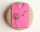 Heart dandelion graphic tee from Anchored Grace Boutique featuring a floral dandelion design on soft cotton fabric.
