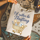 I'd Rather Be Thrifting graphic tee by Anchored Grace Boutique, featuring a casual cotton t-shirt with thrift shopping design.