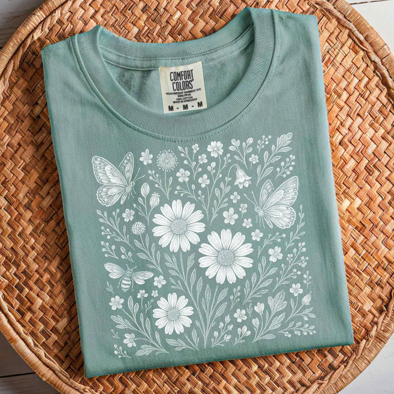 Dainty floral graphic tee from Anchored Grace Boutique featuring a colorful floral design on soft cotton fabric.