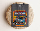 Black graphic tee featuring a colorful squawk graphic design, made by Anchored Grace Boutique.