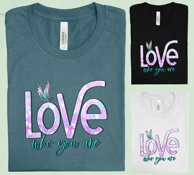 Pink graphic tee by Anchored Grace Boutique with "Love Who You Are" slogan, casual fit, and soft cotton fabric.
