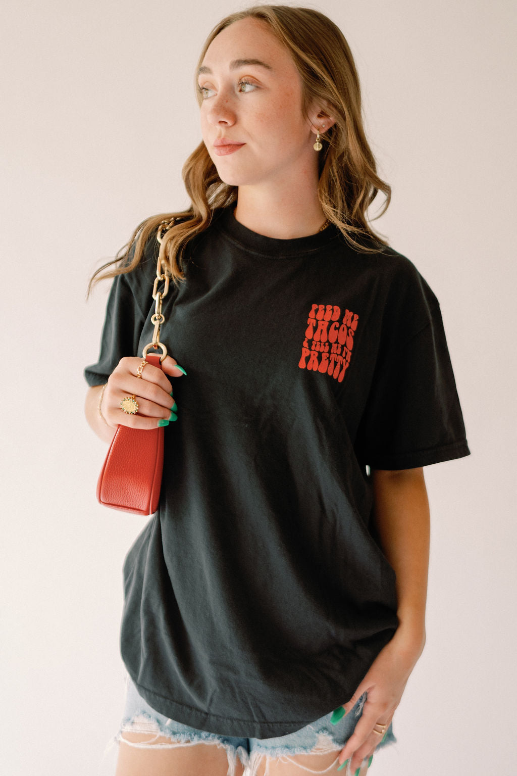 Feed Me Tacos graphic tee from Shop Karma Tees featuring a colorful taco illustration on soft cotton fabric.