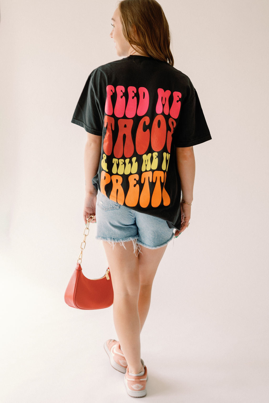 Feed Me Tacos graphic T-shirt by Shop Karma Tees featuring a colorful taco design on soft cotton fabric.