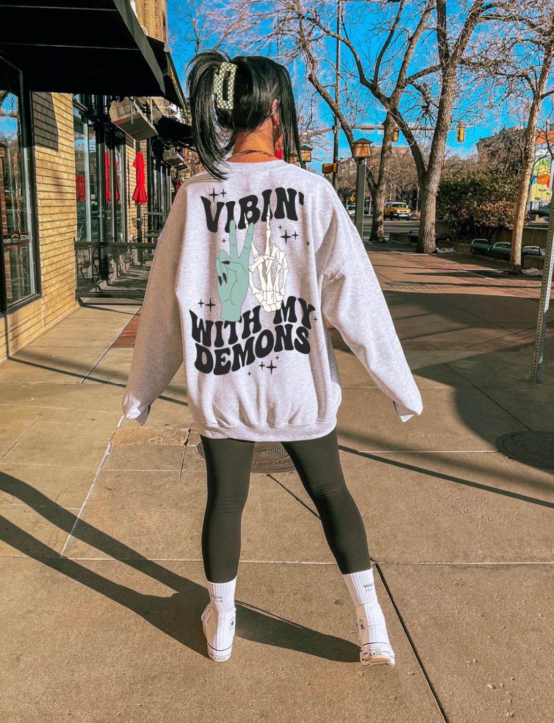 Black graphic sweatshirt from Shop Karma Tees featuring "Vibin' with My Demons" design and bold text on the front.