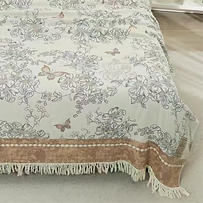CozyNest Decor boho muslin twin size cotton blanket with floral print, tassels, and soft, breathable gauze for sofa or bed.