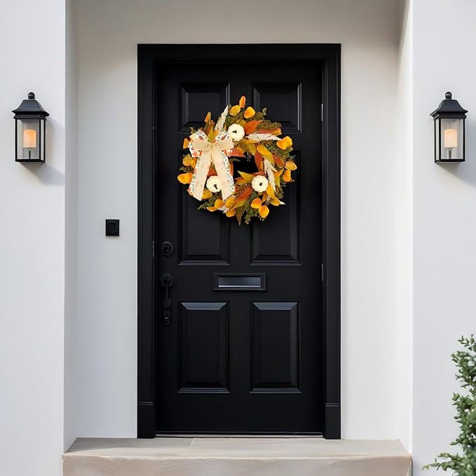 Rustic fall wreath with white pumpkins, golden eucalyptus, wheat, and bow, perfect for front door decor in autumn.