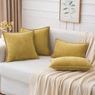 Two mustard yellow CozyNest Decor throw pillow covers, 12x20 inches, soft chenille with stitched edges for sofa or bed decor.