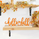 CozyNest Decor metal Hello Fall sign in orange with pumpkin design, perfect for autumn home or office fall decorations.